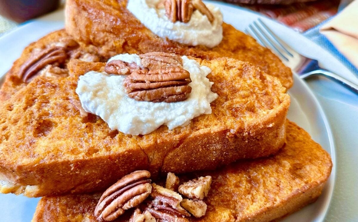 oven-baked French toast with pumpkin batter, coconut whipped cream, cinnamon and pecans