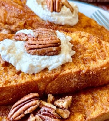 oven-baked French toast with pumpkin batter, coconut whipped cream, cinnamon and pecans