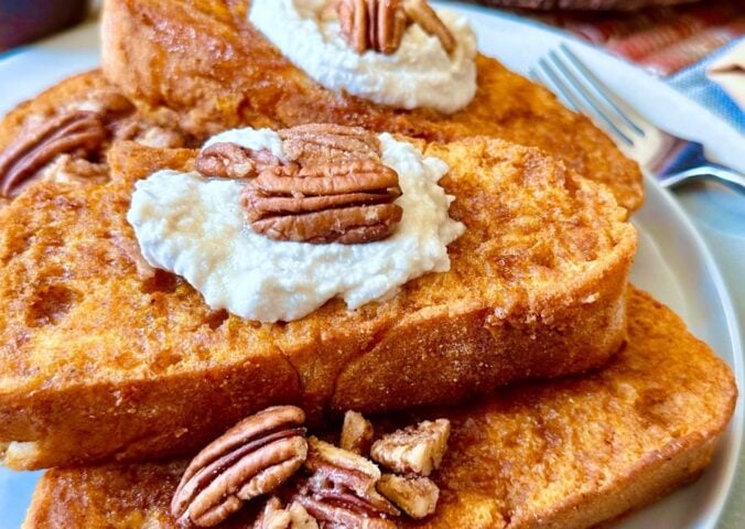 oven-baked French toast with pumpkin batter, coconut whipped cream, cinnamon and pecans