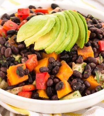 smoky sweet potato salad with black beans, bell pepper, lime, maple syrup, and spices