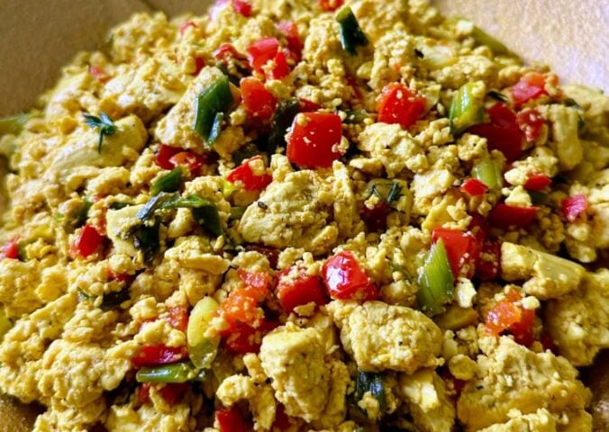 tofu breakfast scramble made with Himalayan black salt, turmeric, bell peppers, and onions