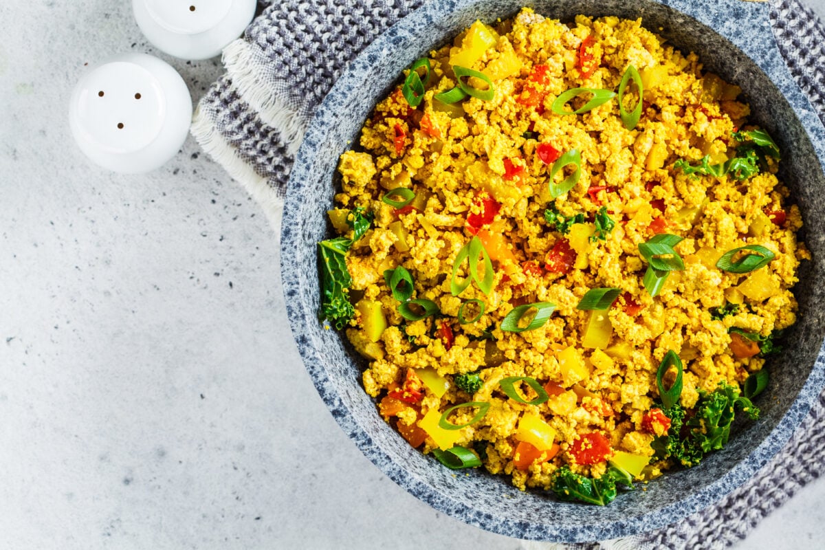 A large bowl filled with colorful tofu scramble, a doctor-recommended vegan breakfast