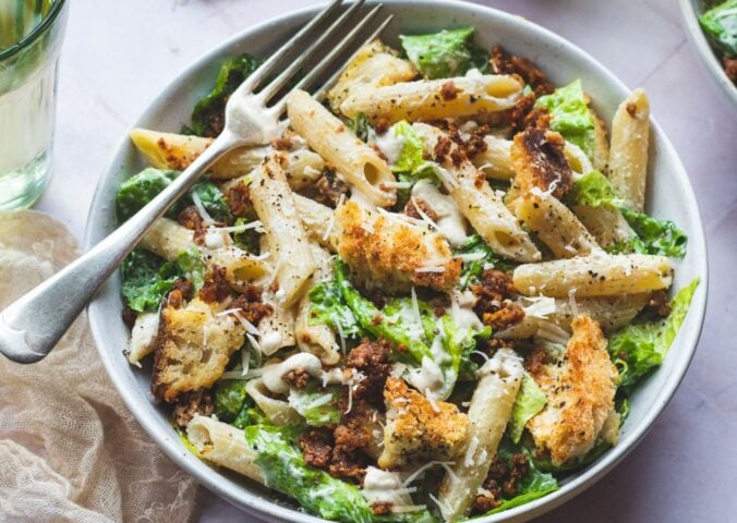 A bowl of vegan pasta caesar salad made to a dairy-free recipe