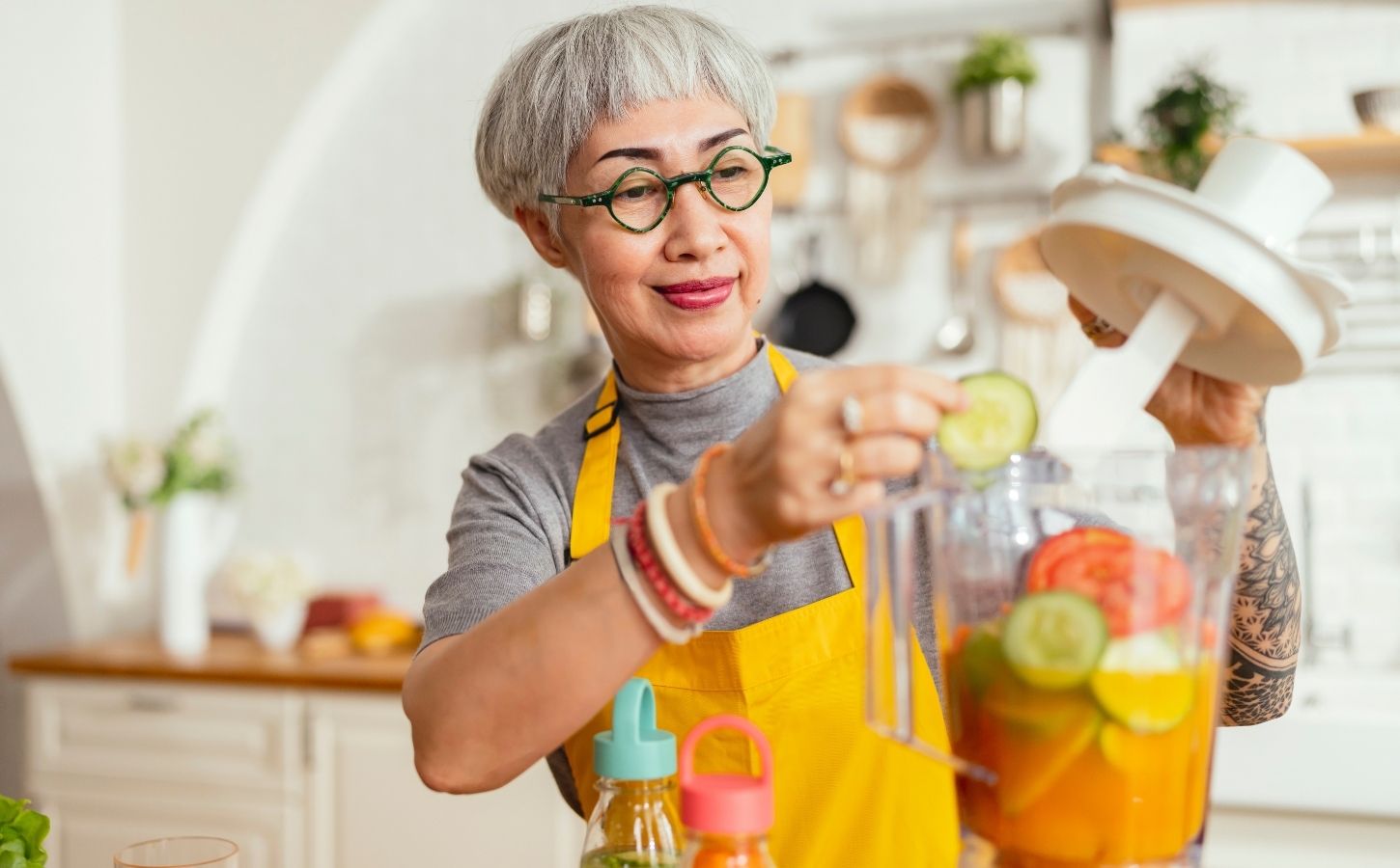 A woman cooking healthy plant-based food in a food processor