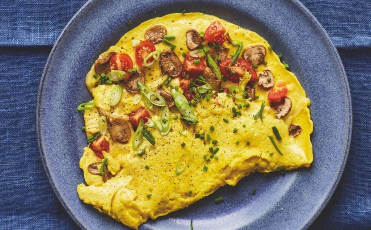 Photo shows a mushroom omelet prepared to a vegan recipe using tofu as a plant-based egg replacer