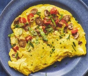 Photo shows a mushroom omelet prepared to a vegan recipe using tofu as a plant-based egg replacer