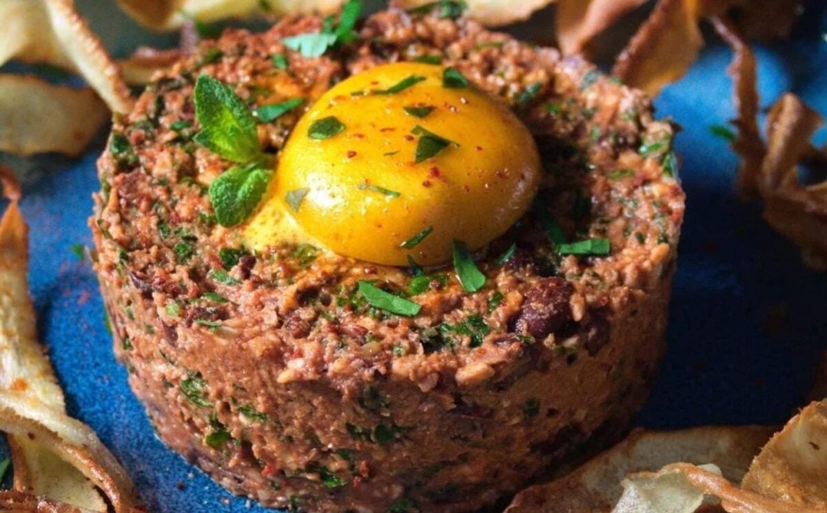 Photo shows a vegan walnut pâté topped with a plant-based chickpea egg