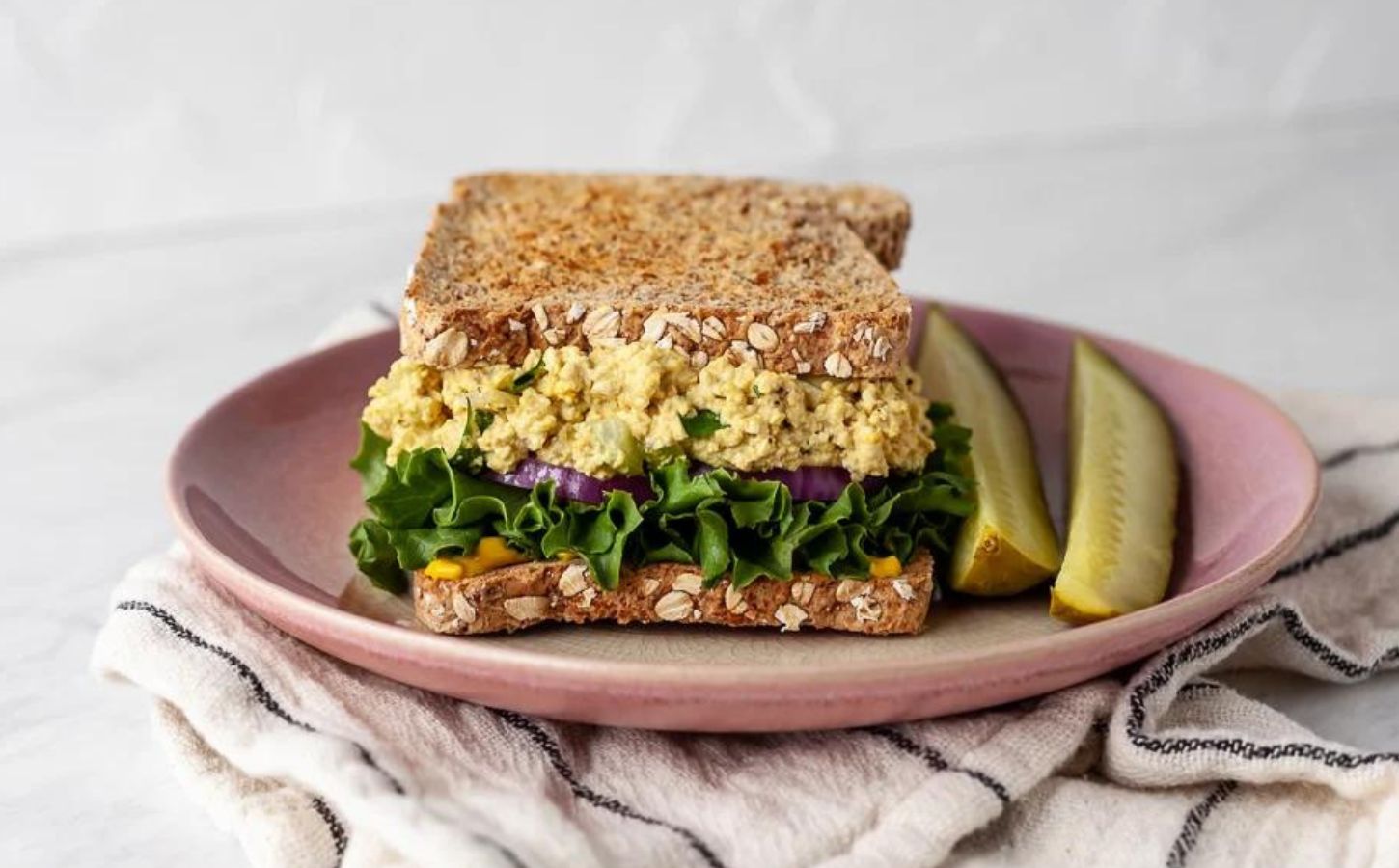 A vegan egg salad sandwich made to a plant-based and egg-free recipe