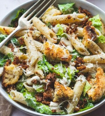 A bowl of plant-based caesar pasta salad, a vegan pasta salad recipe