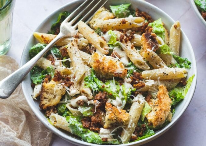 A bowl of plant-based caesar pasta salad, a vegan pasta salad recipe