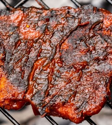 Homemade vegan seitan chicken being grilled on a BBQ