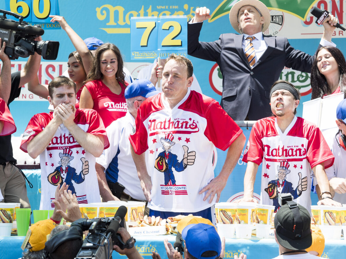 Joey Chestnut and other competitive hot dog eaters at a hot dog eating competition