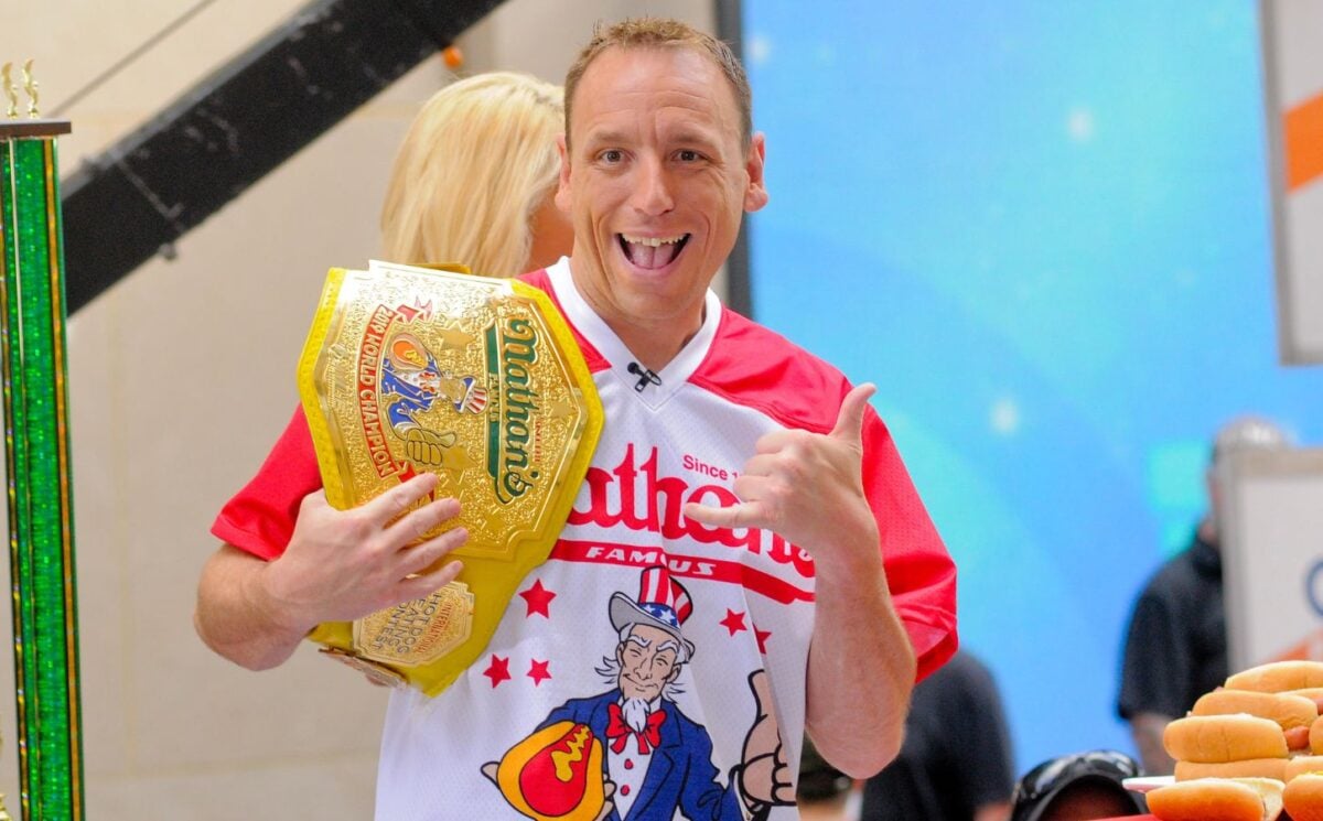 Hot dog eating champ Joey "Jaws" Chestnut doing a thumbs up at a competitive eating competition