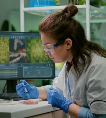 Photo shows a scientist working on some sort of plant-based or alternative protein in a lab setting