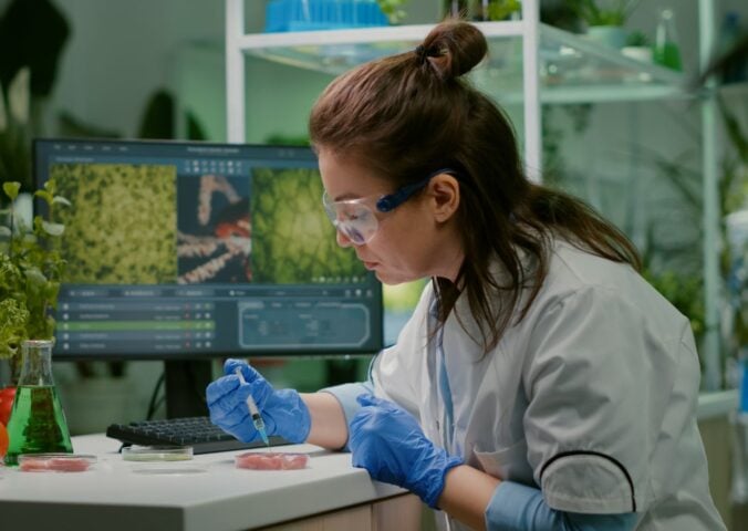 Photo shows a scientist working on some sort of plant-based or alternative protein in a lab setting