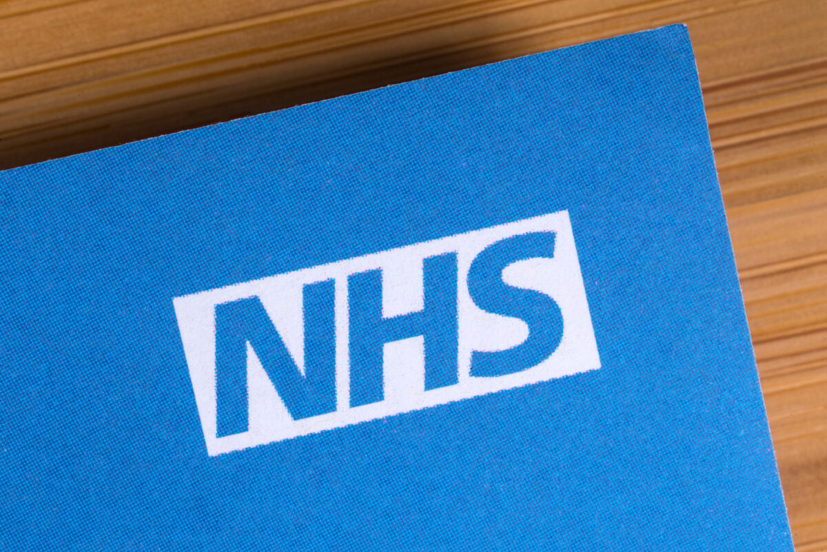 A piece of blue card with the NHS logo on it
