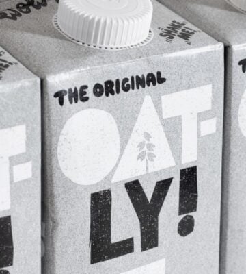 Three cartons of Oatly oat milk. next to each other