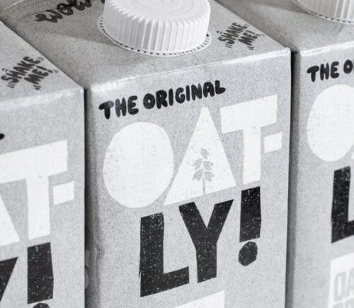Three cartons of Oatly oat milk. next to each other
