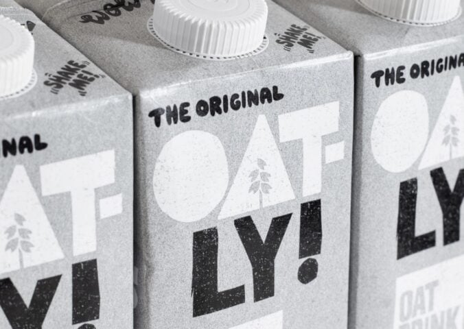 Three cartons of Oatly oat milk. next to each other