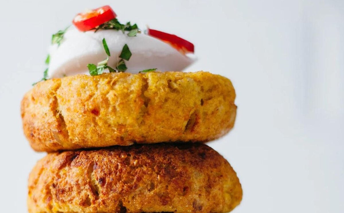 vegan curry-spiced potato and quinoa cakes topped with coconut cream
