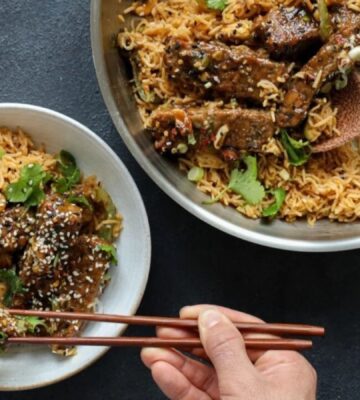 teriyaki glazed tempeh strips cooked with soy, garlic, and sesame over rice