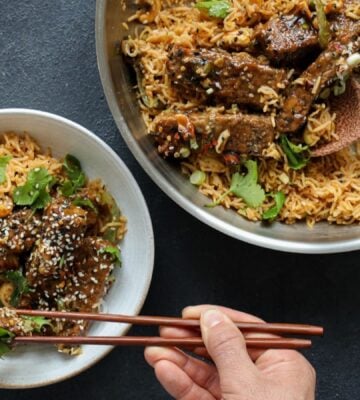 teriyaki glazed tempeh strips cooked with soy, garlic, and sesame over rice