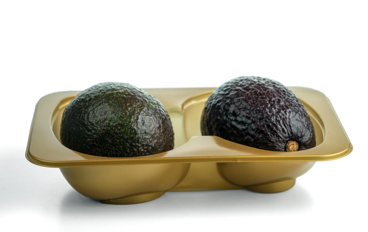 Photo shows two avocados in a plastic tray