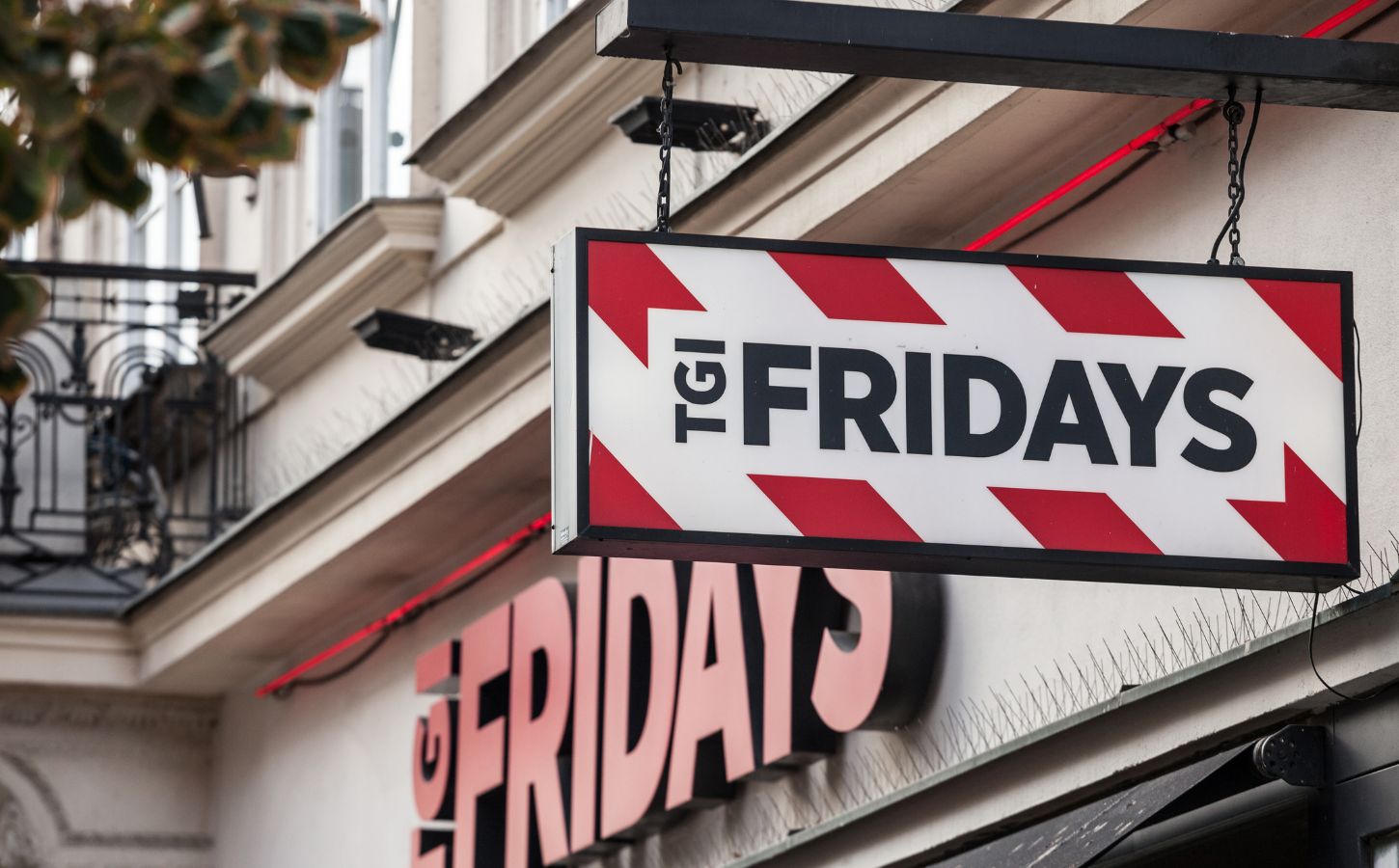 Photo shows a hanging sign for TGI Fridays outside a location in Prague, Czechia