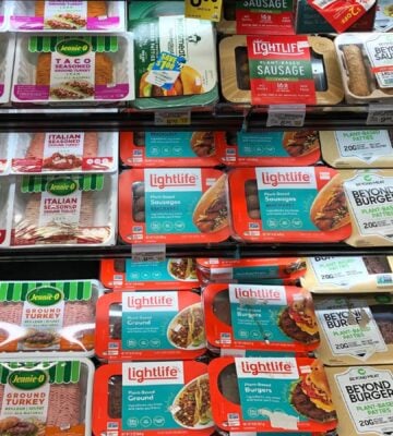 A selection of vegan meat next to animal meat at the supermarket