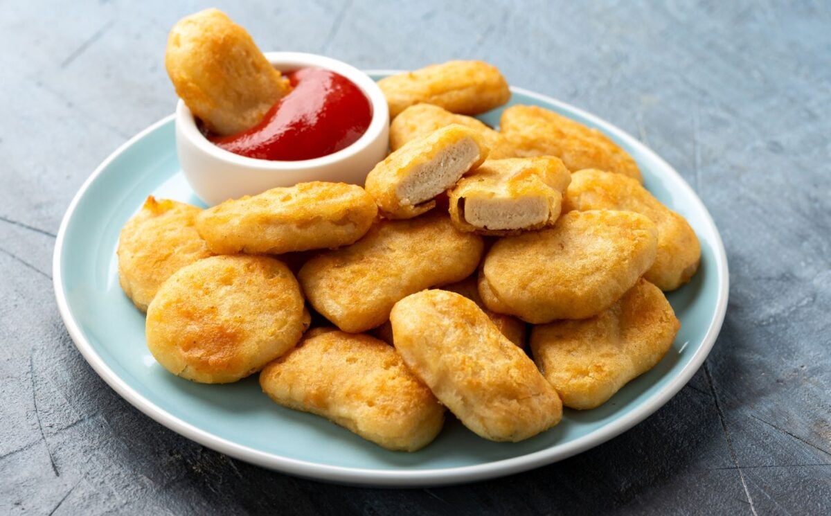 A plate full of vegan chicken nuggets with a pot of tomato ketchup