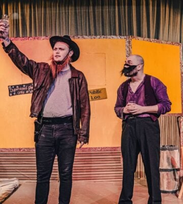 Two actors on stage at a meat industry play at the UK's first vegan theater