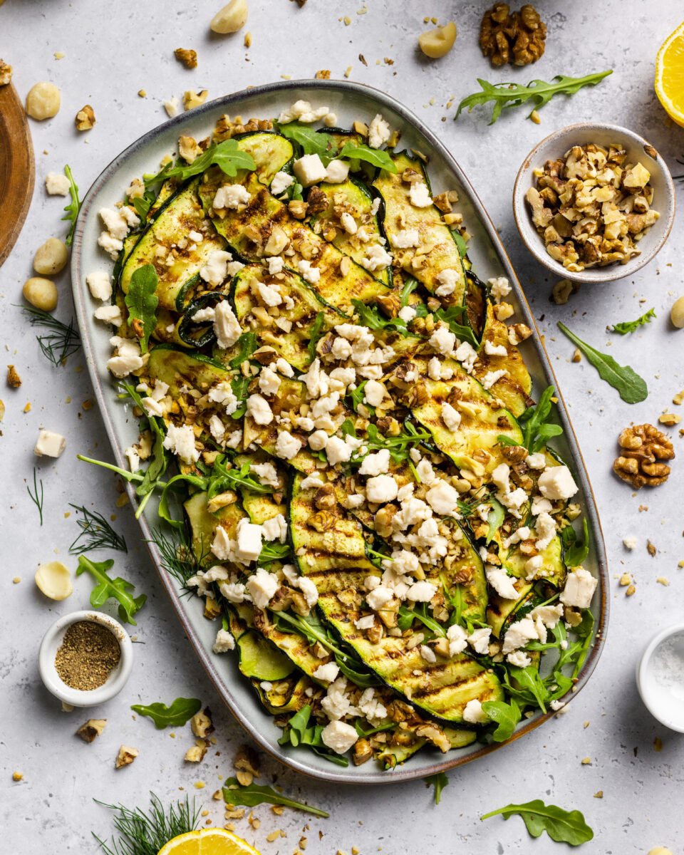 A large plate of zucchini salad made with macadamia nut-based dairy-free feta