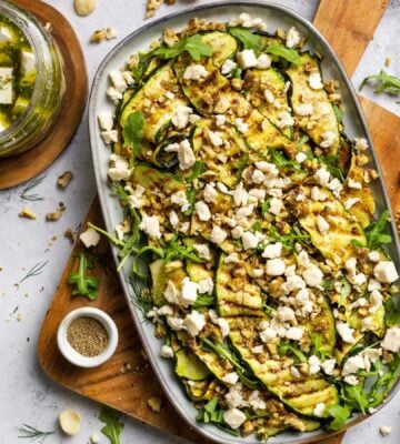 A large plate of zucchini salad made with macadamia nut-based dairy-free feta