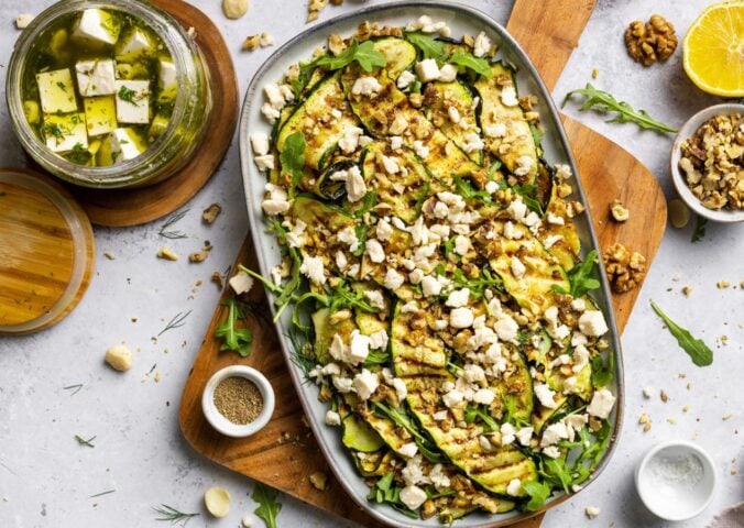 A large plate of zucchini salad made with macadamia nut-based dairy-free feta