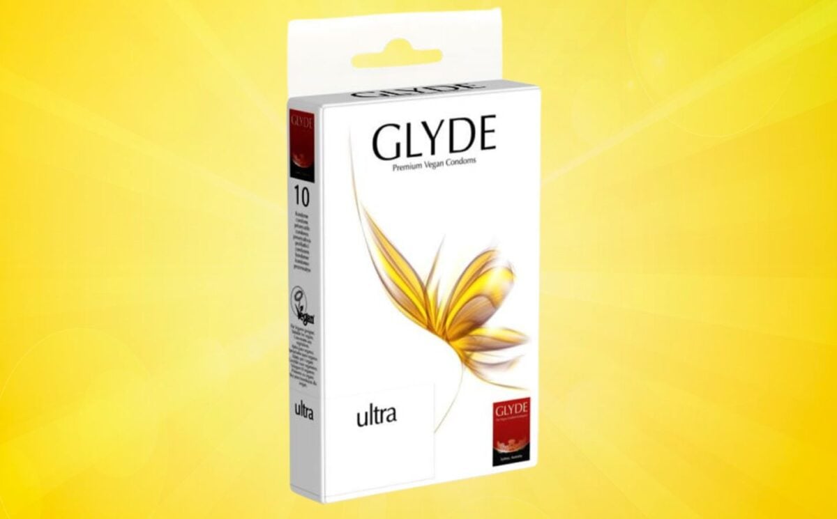 A pack of Glyde vegan condoms in front of a yellow background