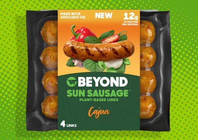 A packet of Beyond Meat's new healthier less processed Sun Sausages in front of a green background