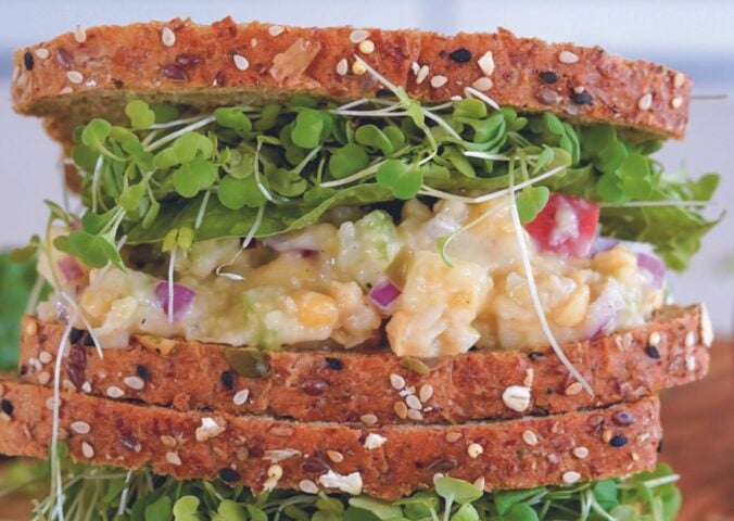 A vegan sandwich made with a chickpea sandwich filling
