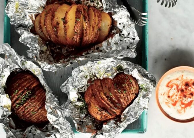 A hasselback sweet potato made to a vegan recipe