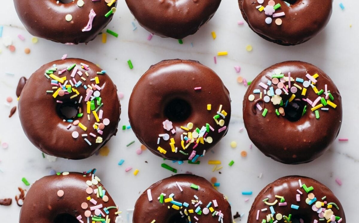 rows of vegan homemade chocolate donuts topped with sprinkles