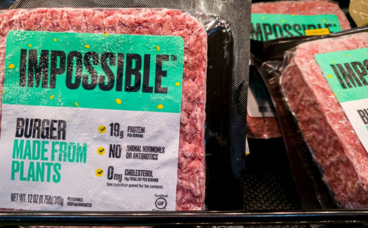 Some frozen Impossible vegan burgers on a supermarket shelf