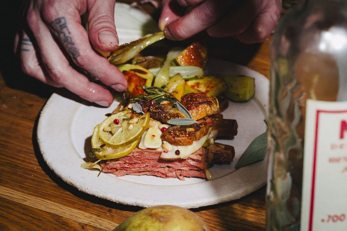 Photo shows a Juicy Marbles chef plating up its new vegan Baby Ribs