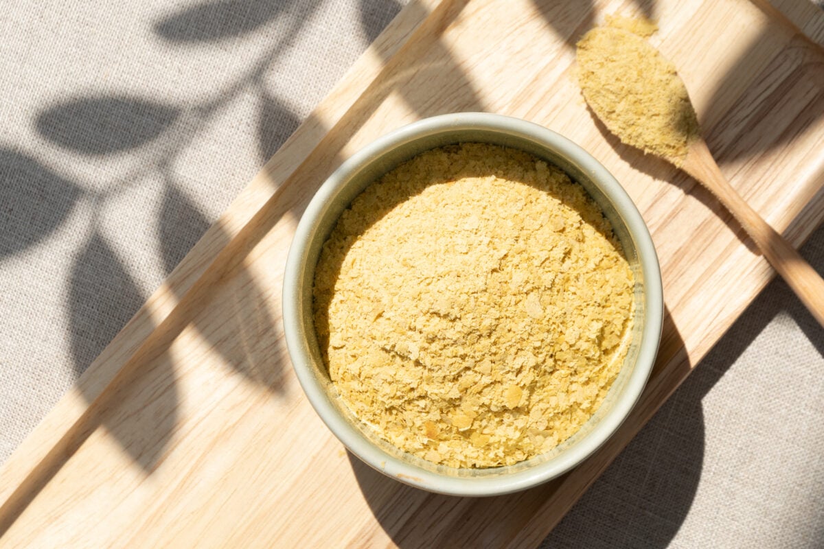 A bowl full of nutritional yeast, a complete plant-based source of protein