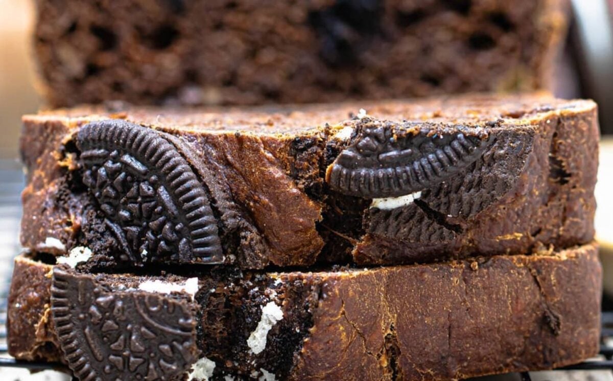 a picture of a sliced loaf of vegan chocolate banana bread with pieces of Oreo cookie in it