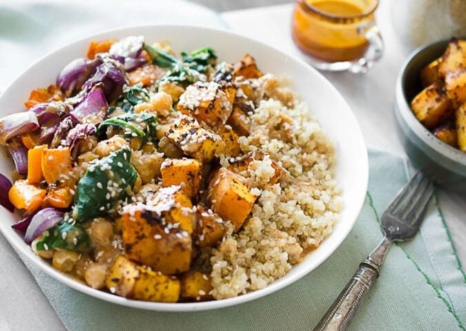 Photo shows a roasted squash and quinoa buddha bowl recipe by Ashley Madden of Rise Shine Cook