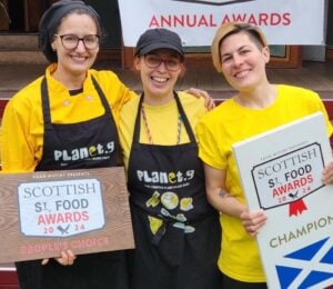 The three owners of Planet G, a vegan food brand from Scotland, holding their Scottish Street Food award