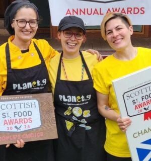 The three owners of Planet G, a vegan food brand from Scotland, holding their Scottish Street Food award