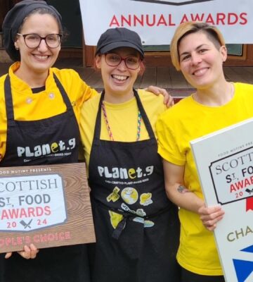 The three owners of Planet G, a vegan food brand from Scotland, holding their Scottish Street Food award