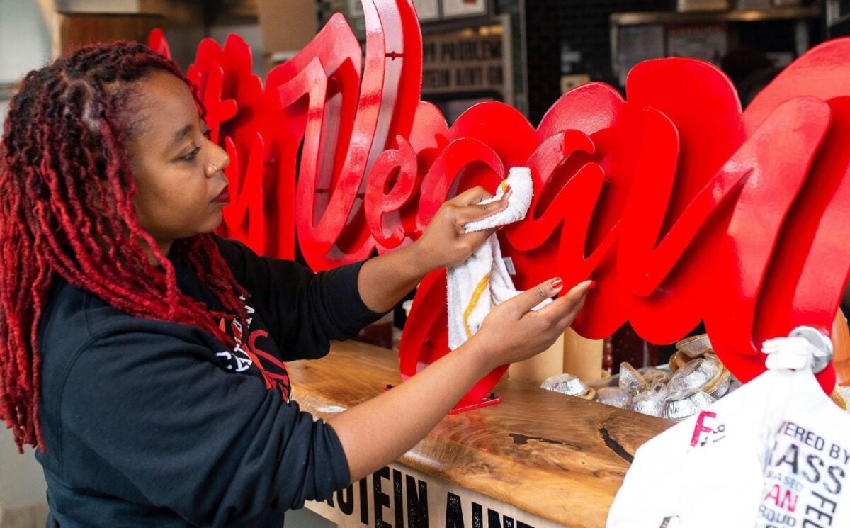 Slutty Vegan founder Pinky Cole cleaning the shop front of her Atlanta branch