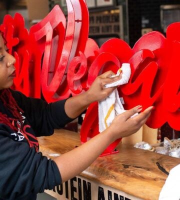 Slutty Vegan founder Pinky Cole cleaning the shop front of her Atlanta branch