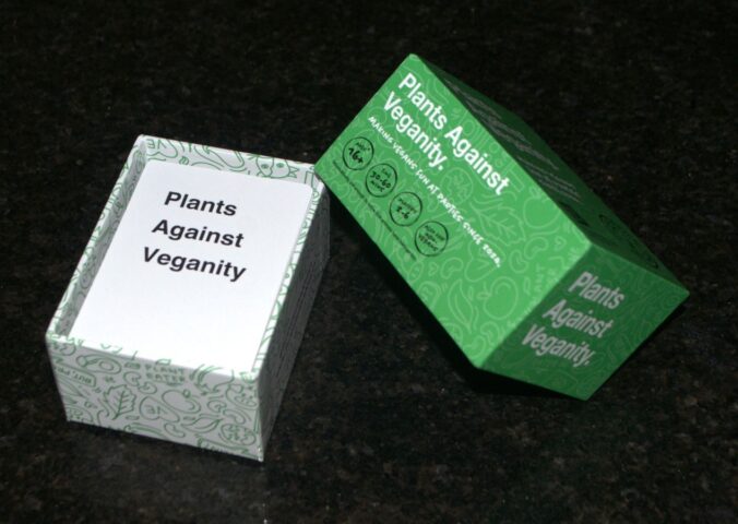 Photo shows the green and white box for This Is Not A Game's "Plants Against Veganity" vegan card game